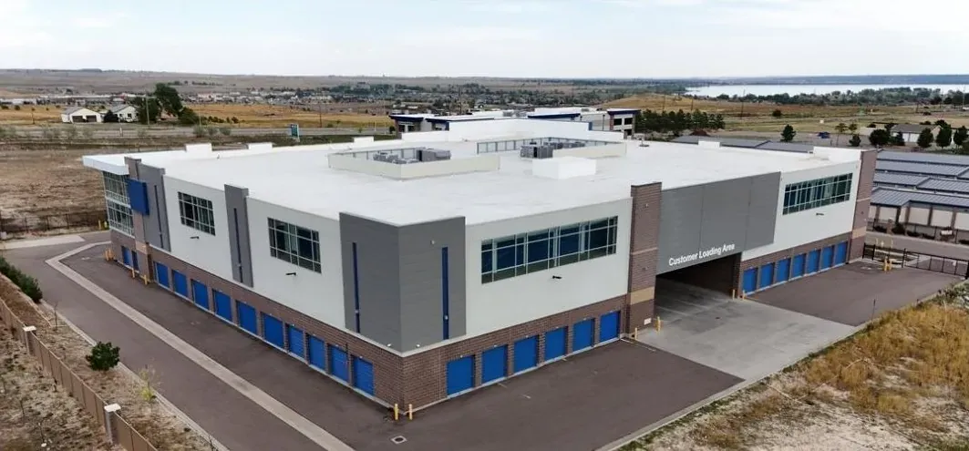 Drive-up storage units with ample parking space.