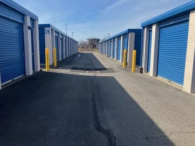 Drive-up storage units with wide aisles for vehicle access.