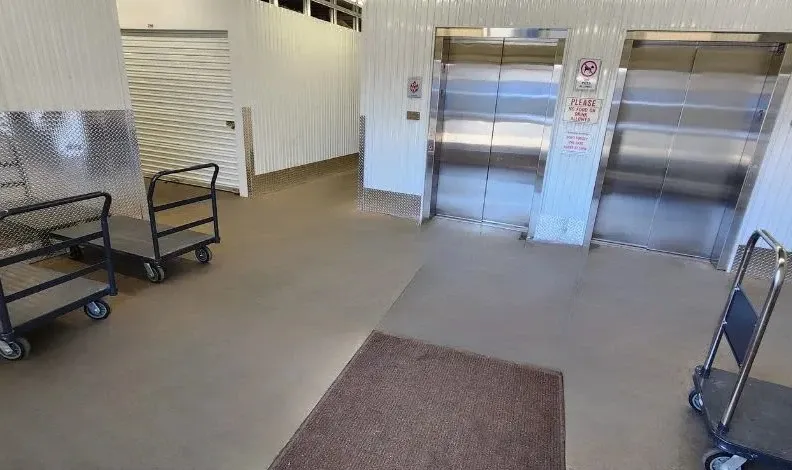Elevator lobby area with dollies and carts for moving items